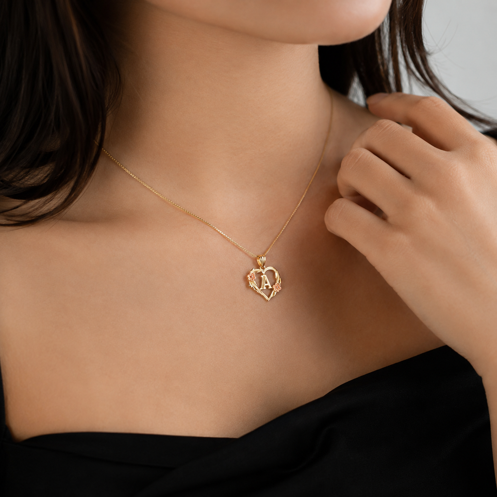 Model wearing 10K gold heart and flower initial pendant necklace