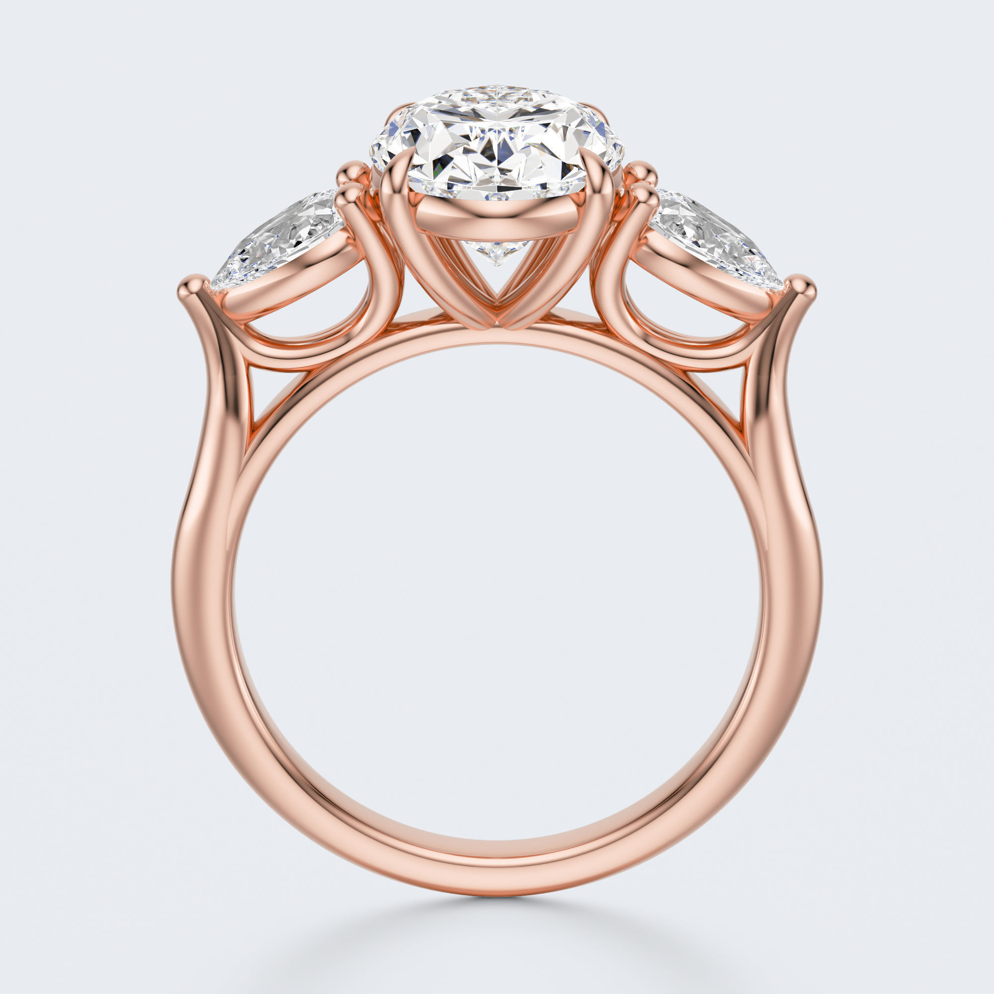 Rose gold three-stone oval and pear lab-grown diamond engagement ring side profile
