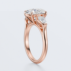 Rose gold three-stone oval and pear lab-grown diamond engagement ring opposite three-quarter view