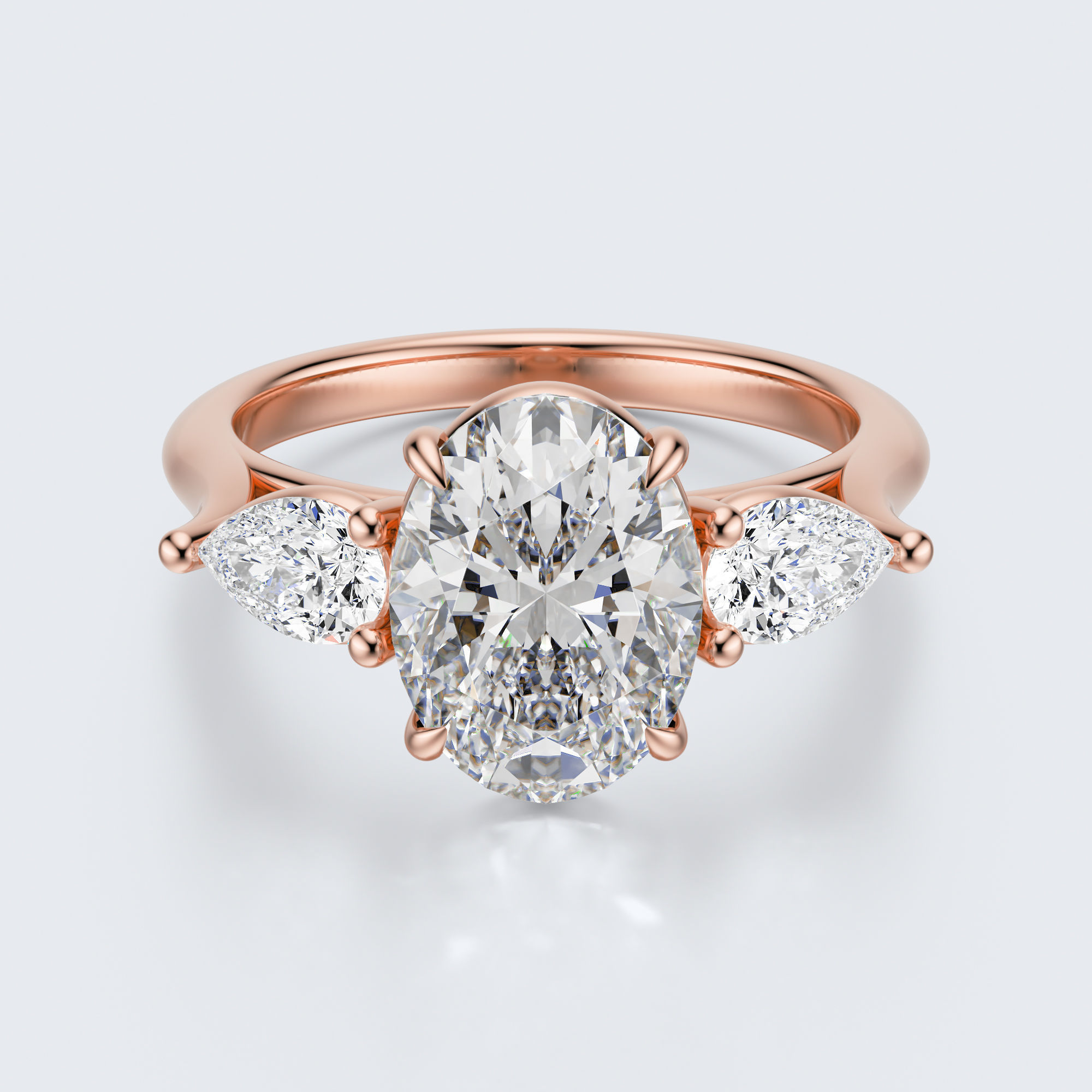 Rose gold three-stone oval and pear lab-grown diamond engagement ring top view