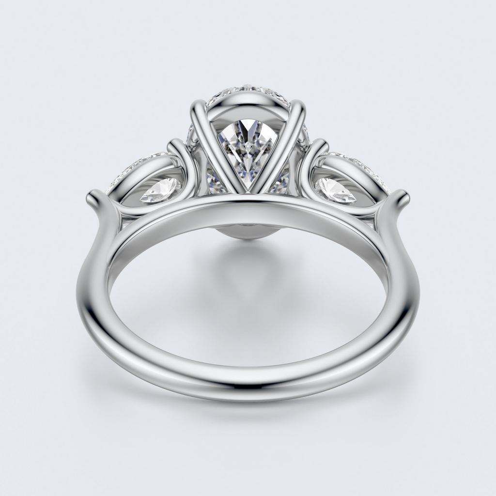 White gold three-stone oval and pear lab-grown diamond engagement ring underside view