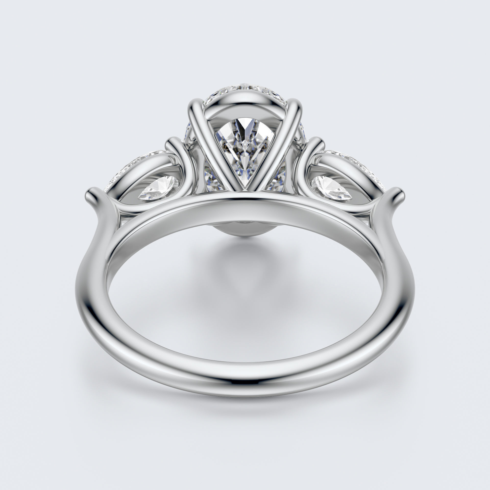 White gold three-stone oval and pear lab-grown diamond engagement ring underside view