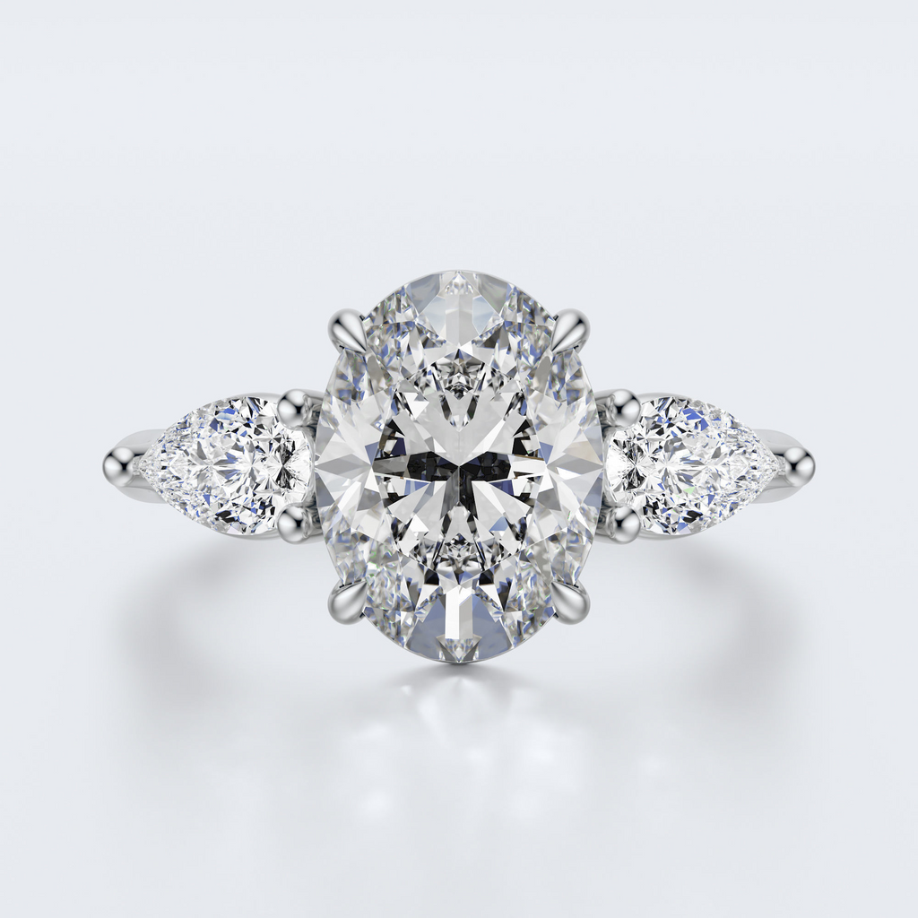 White gold three-stone oval and pear lab-grown diamond engagement ring top view