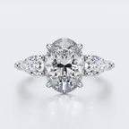 White gold three-stone oval and pear lab-grown diamond engagement ring top view