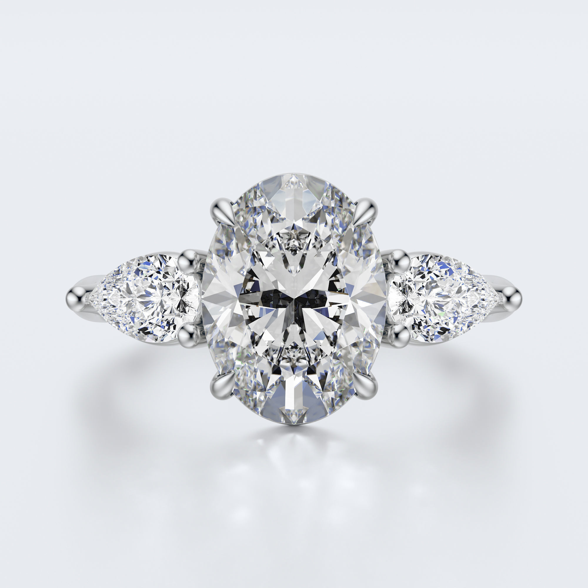 White gold three-stone oval and pear lab-grown diamond engagement ring top view