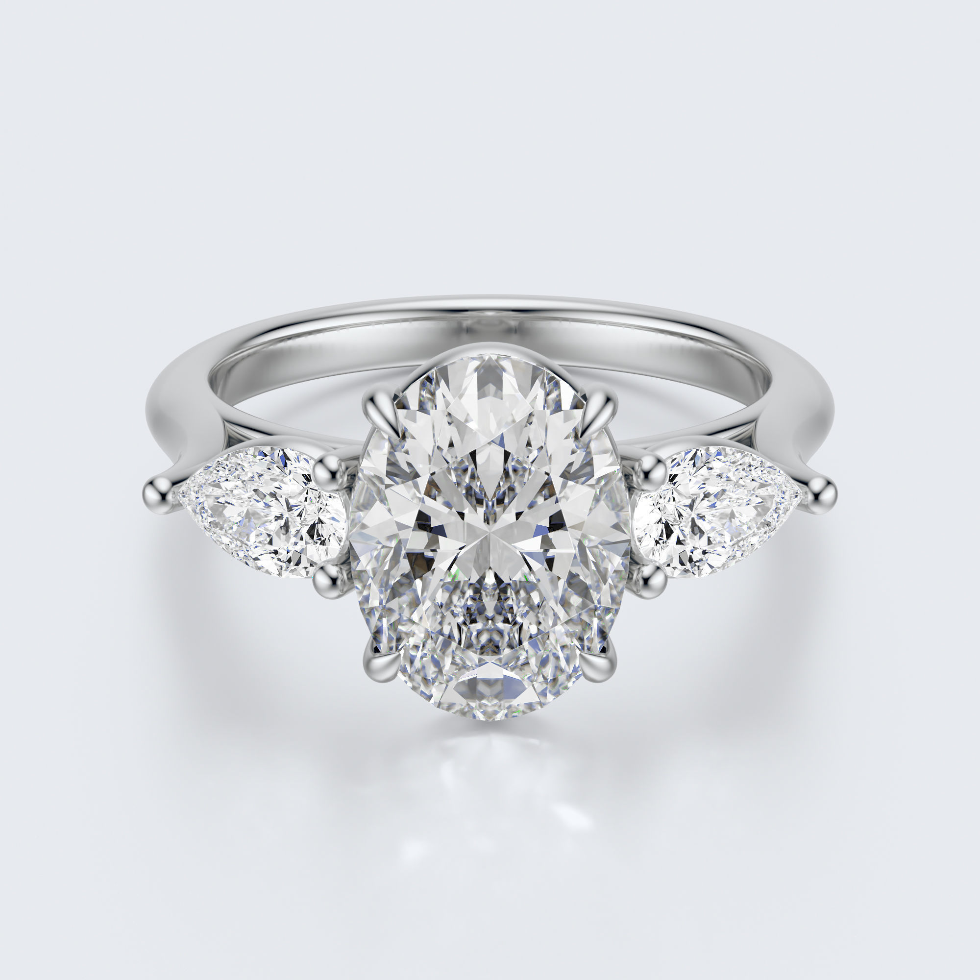 White gold three-stone oval and pear lab-grown diamond engagement ring front view