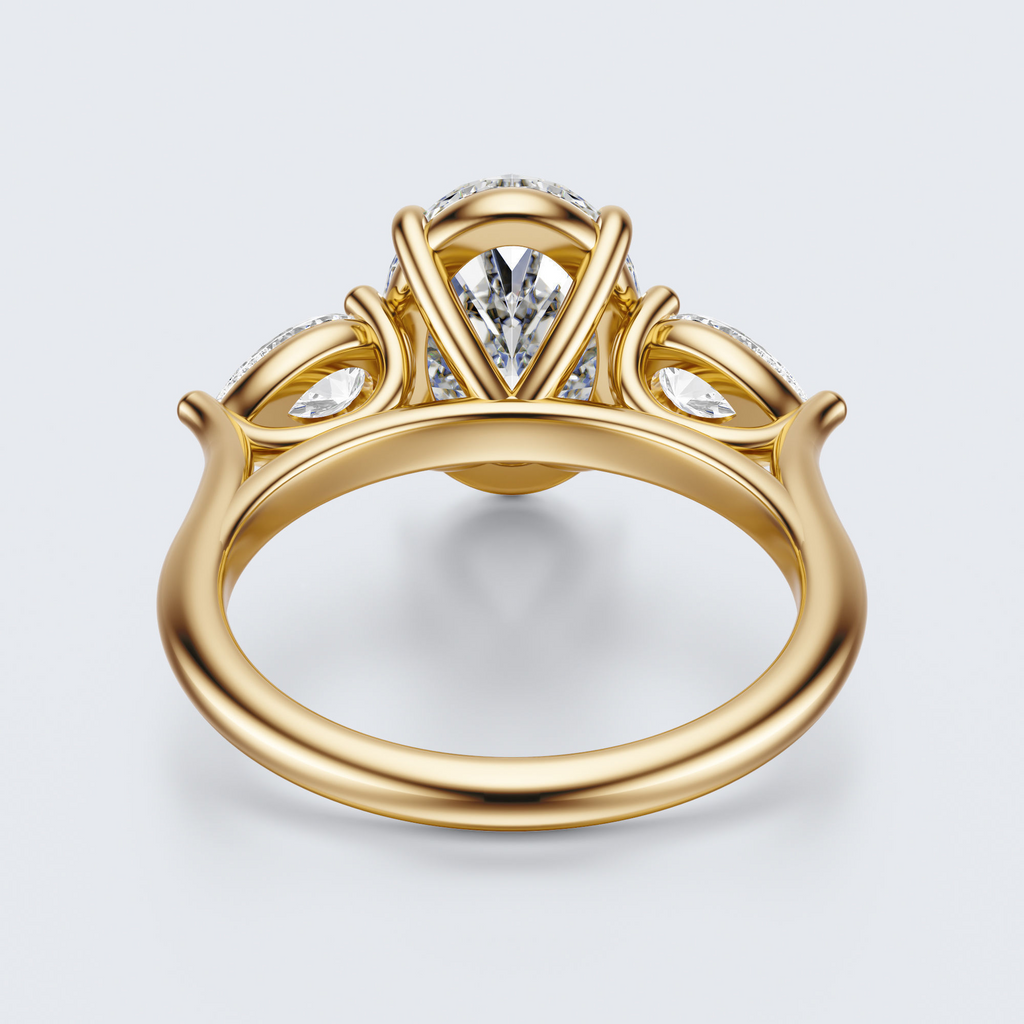 Yellow gold three-stone oval and pear lab-grown diamond engagement ring underside view