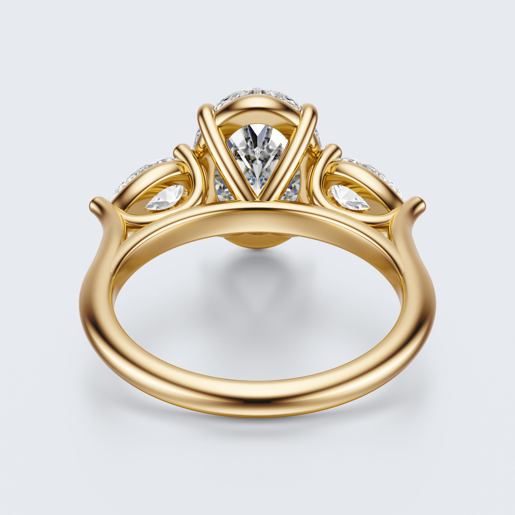 Yellow gold three-stone oval and pear lab-grown diamond engagement ring underside view