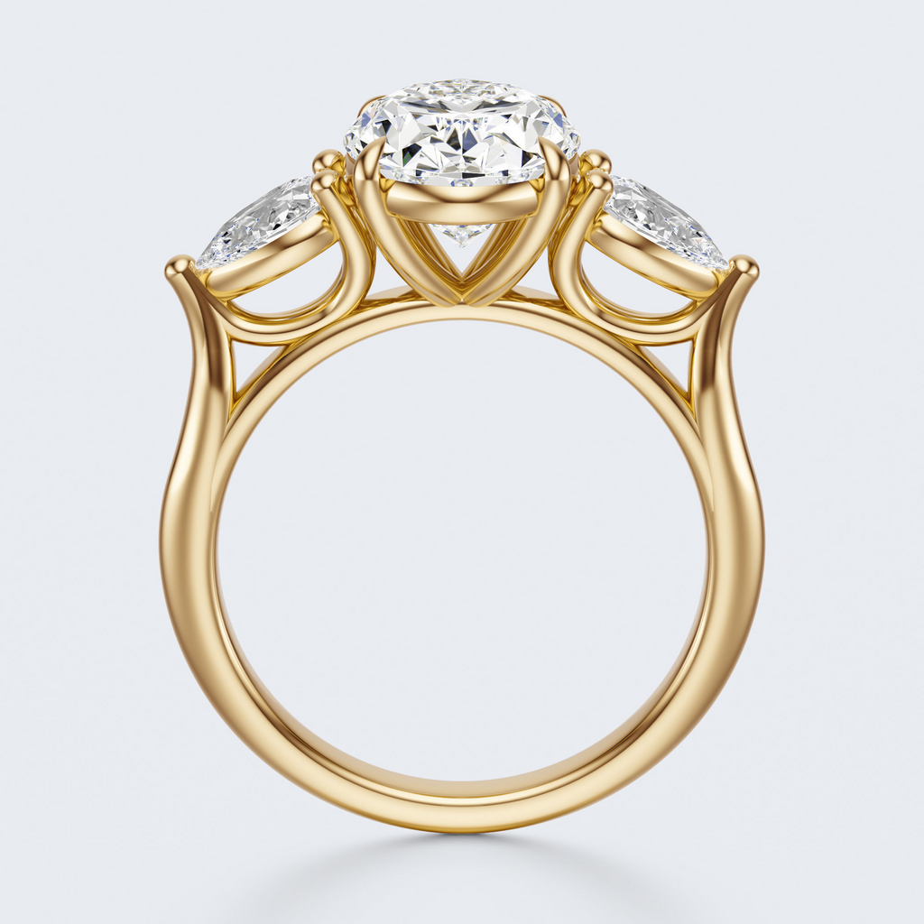 Yellow gold three-stone oval and pear lab-grown diamond engagement ring side profile