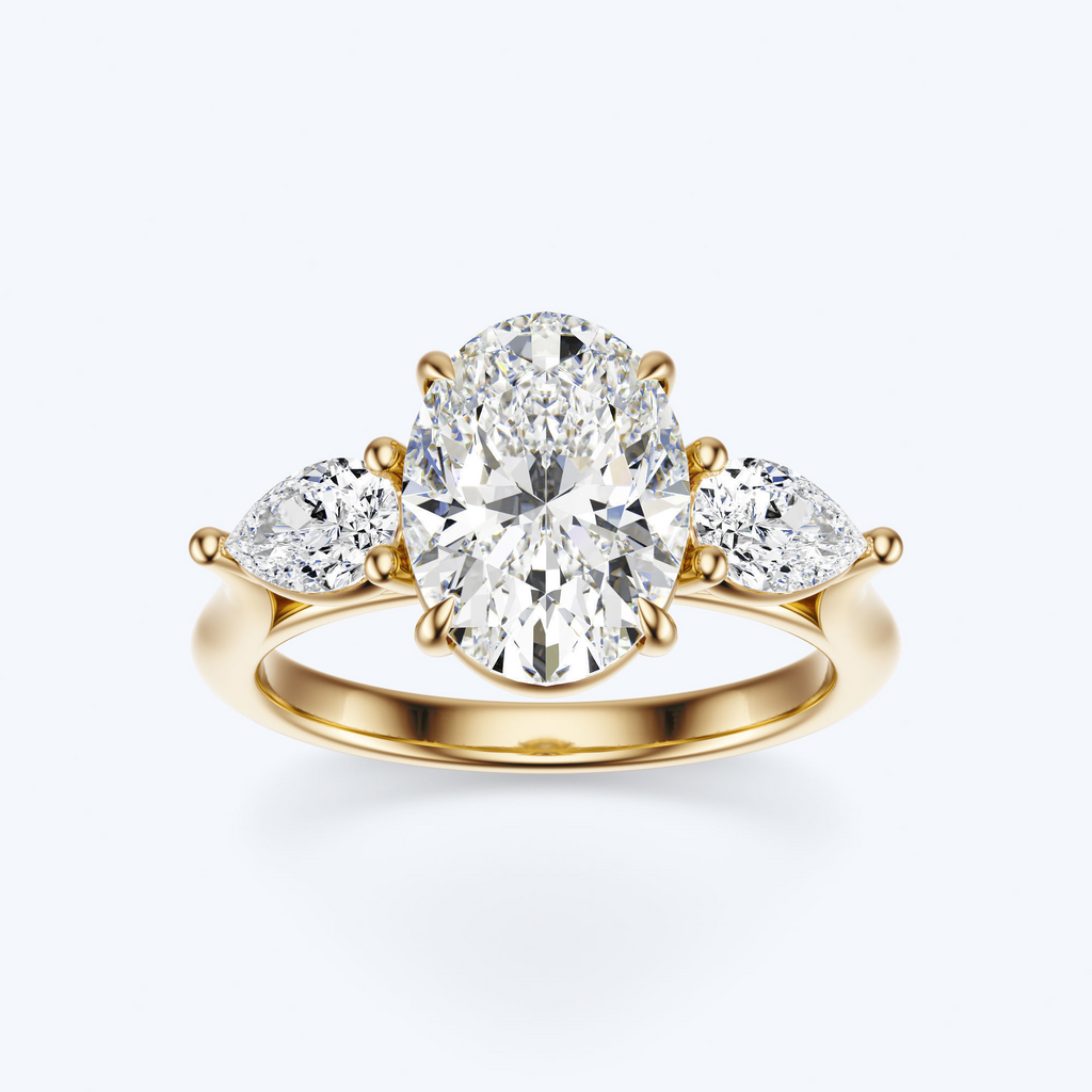 Yellow gold three-stone oval and pear lab-grown diamond engagement ring front view