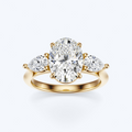 Yellow gold three-stone oval and pear lab-grown diamond engagement ring front view