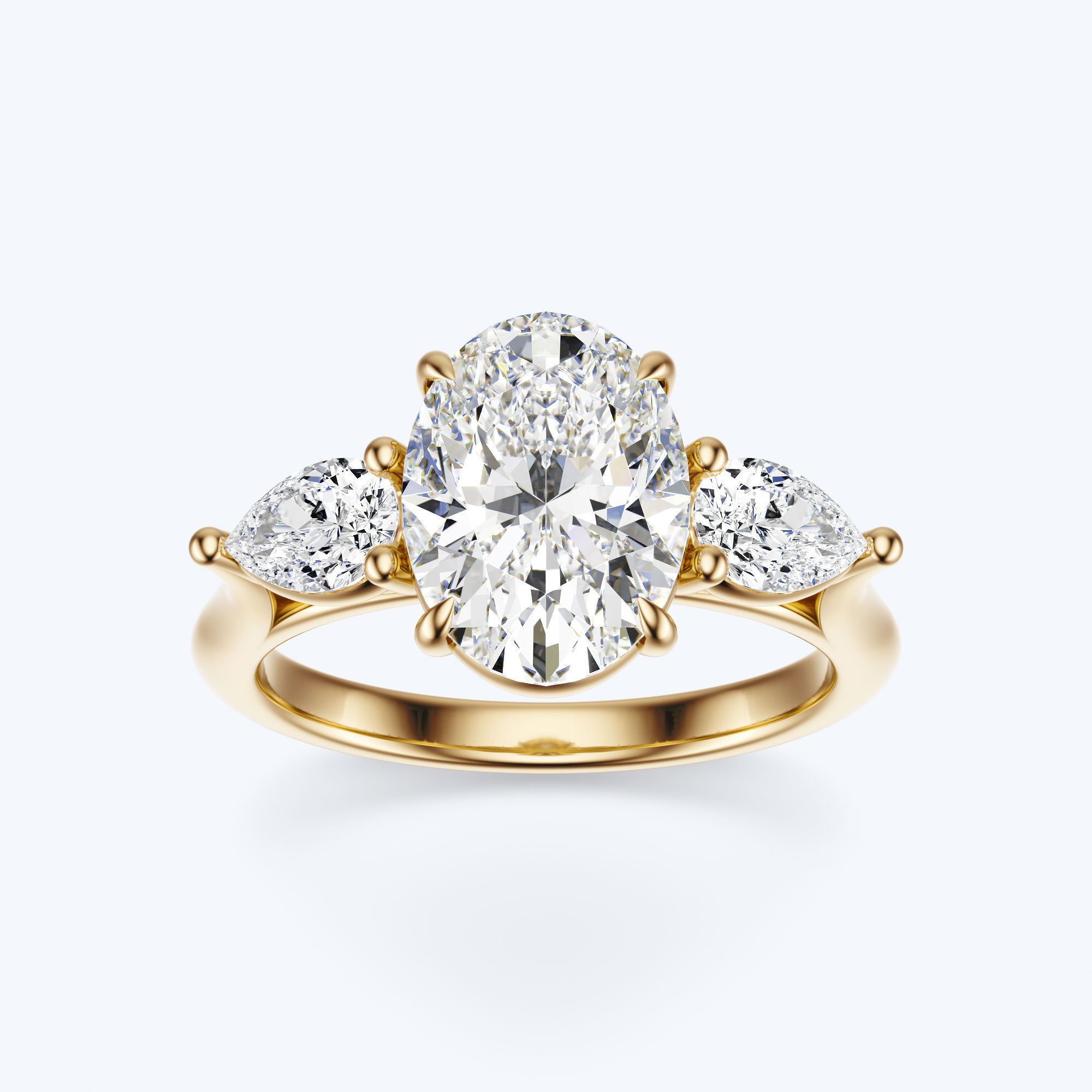 Yellow gold three-stone oval and pear lab-grown diamond engagement ring front view