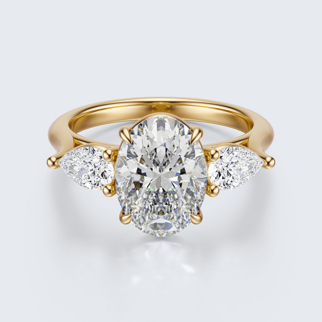 Yellow gold three-stone oval and pear lab-grown diamond engagement ring top view