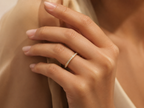 Infinity one-row lab grown diamond eternity band worn on hand in 14K yellow gold