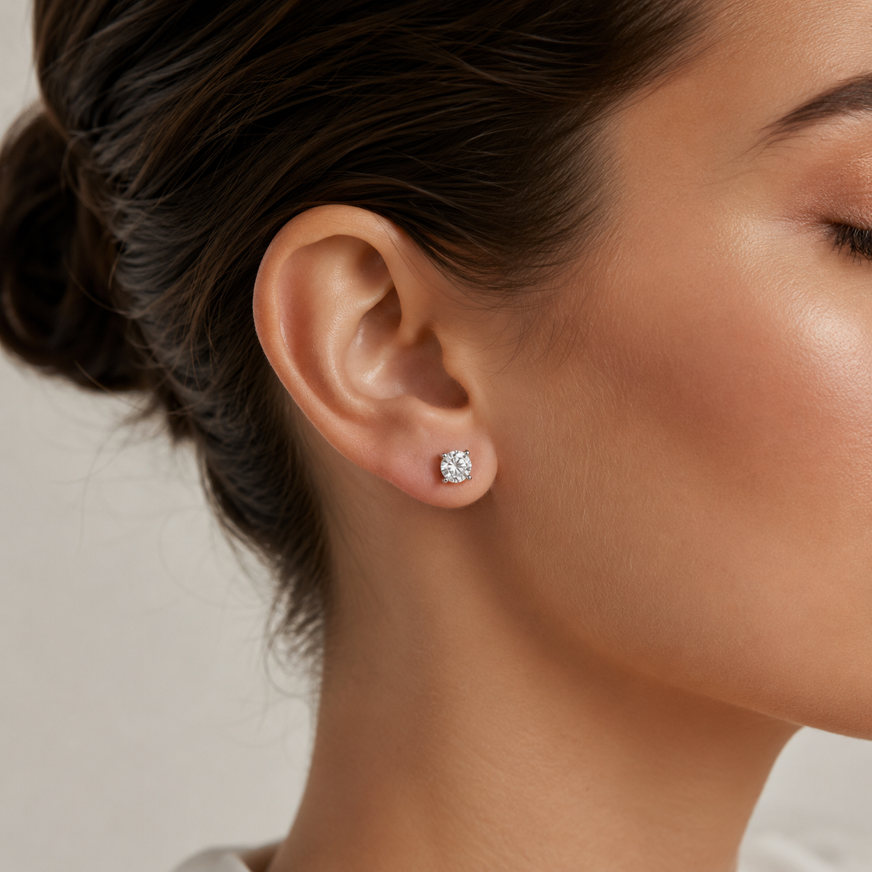 Model wearing round solitaire lab grown diamond stud earring